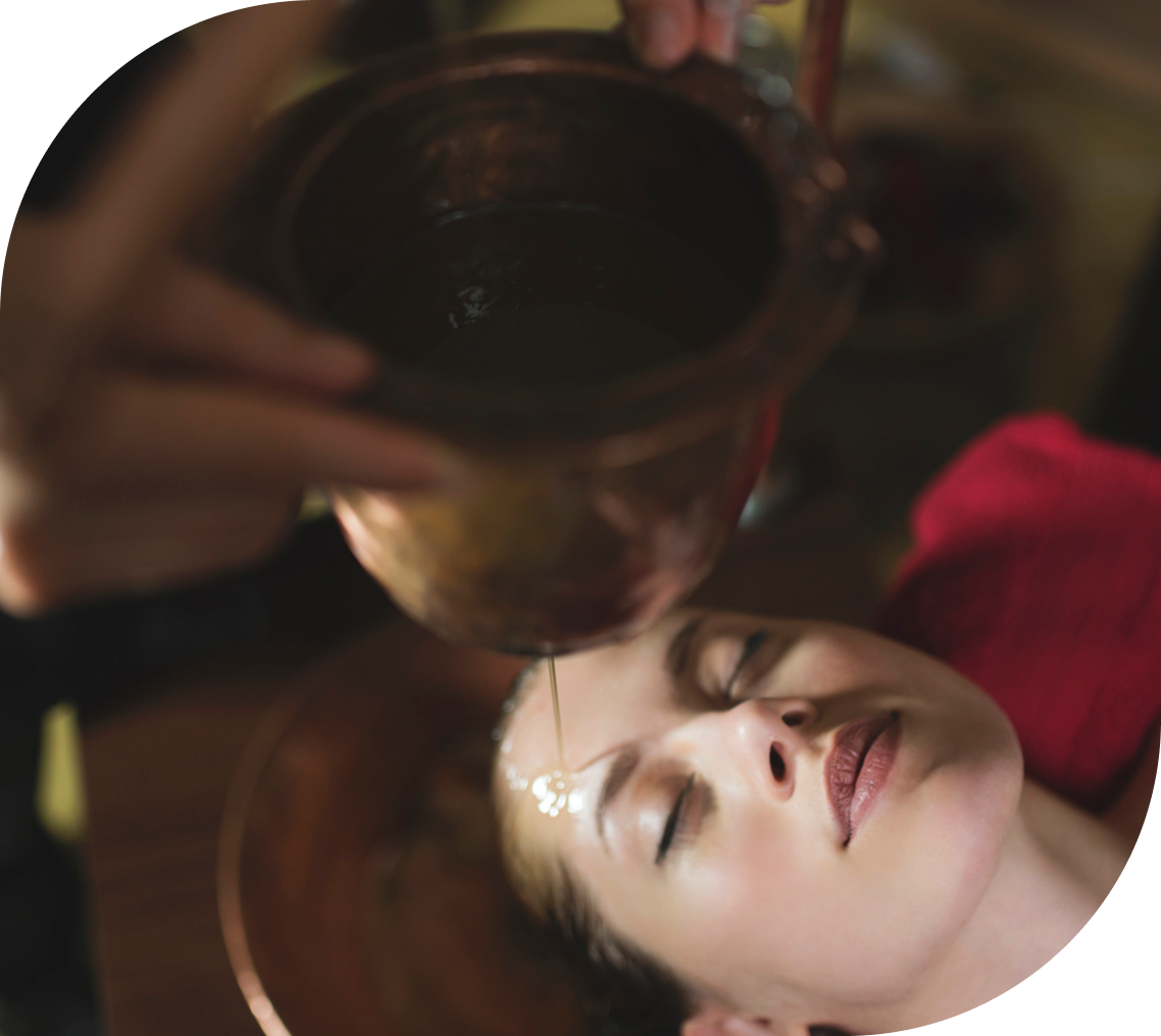 Woman receiving traditional oil massage therapy